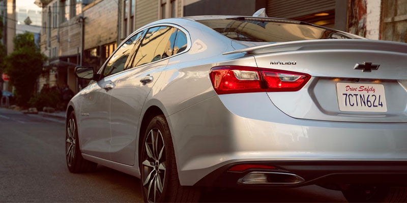 Two ladies walking by a Chevy Trax